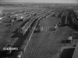 1953: UNION PACIFIC FREIGHT YARD: VS Freight cars in train yard, INT Harry Carpenter sitting at freight desk filling out destination tags '4' & '5', handing them off to male. Instructional Video