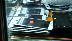 Engineer assembling Iphone and phones on shelf News Clip