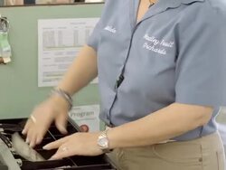 CU elderly female cashier opens cash drawer at check-out register and retrieves change in dollar bills and coins and hands it over / Cabazon, California, USA Stock Footage