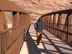 Man walking on a bridge. Stock Footage