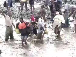 Family crossing river following bridge collapse Stock Footage