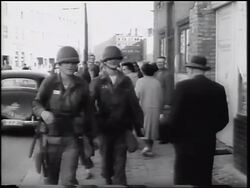 B/W 1961 two US soldiers walking on busy city sidewalk / Berlin, Germany / newsreel Stock Footage