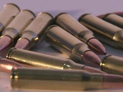 Close Up pan-right - Rifle bullets lie on a flat surface /  Maryland, United States Stock Footage