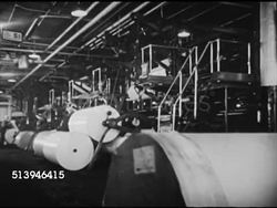 1939: TIME & LIFE CHICAGO: VS Chicago exterior building, INT various workers in printing press factory, male rolling large bale of paper, others operating machines, press rolling, printing. Time & Life, news, newspapers Instructional Video
