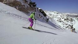 TS Woman skiing down ski slope Stock Footage