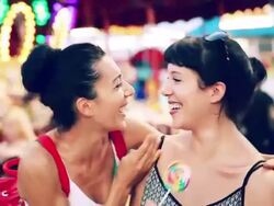 Hands covering eyes. Women play at amusement park Stock Footage