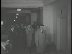 A suspect in the Boston Brinks Robbery hides his face as photographers try to take his picture. News Clip