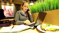 HD:Businesswoman multitasking with laptop cellphone and taking note. Stock Footage