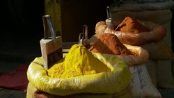 Colorful spices fill sacks at a market. Stock Footage