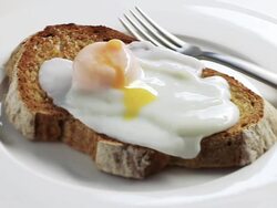  CU Shot of Poached egg running over toast / London, United Kingdom  Stock Footage