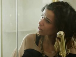 CU Reflection of young woman using curling iron and hairspray in front of bathroom mirror / Provo, Utah, USA Stock Footage