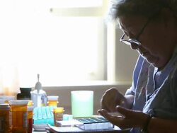 MS Elderly woman putting prescription medication in pill box / Minneapolis, Minnesota, United States Stock Footage