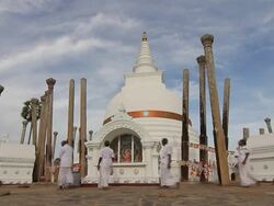 MS T/L Worshippers circle Thuparama Dagoba, first dagaba built in Sri Lanka after introduction of Buddhism, contains collarbone of Buddha / Anuradhapura, North Central Province, Sri Lanka Stock Footage