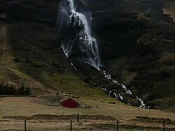 WS View of Waterfall near small house / Iceland  Stock Footage