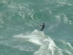 WS AERIAL TS ZI ZO View of windsurfers and kite surfer on ocean at Guinchos beach in Cascais / Lisbon, Portugal Stock Footage
