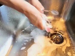 Housewife washing dishes by hand in the sink, close-up Stock Footage
