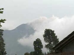 Steam and ash rise from top of Merapi volcano from distance; Central Java, Indonesia. 28 October 2010 Stock Footage