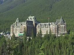 MS View of Banff Springs Hotel surrounded by tree near Bow River / Banff Nationalpark, Alberta, Canada Stock Footage