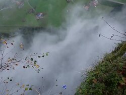 Wing suit flier jumps from cliff and soars above valley below Stock Footage