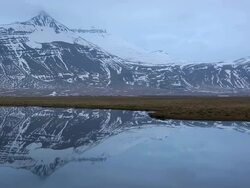 WS PAN Reflection of snow mountain in lagoon / Iceland Stock Footage