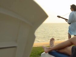 one man play guitar on the beach Stock Footage