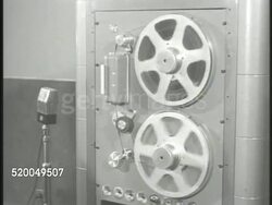 1951: KOREAN WAR: TOKYO RADIO STATION: VS Radio station building sign, 'Radio Tokyo.' INT VS Reel of taped recording spinning, radio operator control panel, tape spinning (SOT of unidentified Communist delegate agreeing to ceasefire & meeting). Instructional Video