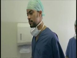 MS medics in surgery gowns scrubbing hands Stock Footage