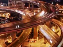 Time lapse long shot elevated walkway over traffic at People's Square / Shanghai Museum / dusk to night / Shanghai Stock Footage