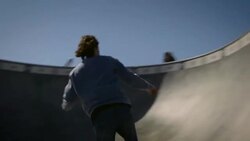 skater skating through dog bowl in venice California skatepark Stock Footage