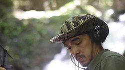 Researchers listen to the radio signal from radio telemetry,tracking to find an wildlife in tropical rainforest Stock Footage