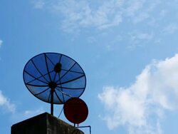 Satellite dish antennas under sky at office building Stock Footage