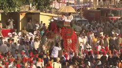 An elephant carries a dignitary through a large crowd during India's Diwali celebration. Stock Footage