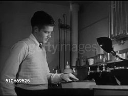 1951: HARVARD UNIVERSITY DORMS: Male students relaxing, watching TV in common room (some smoking cigarettes), male washing developed photograph in solution tray, VS Students studying in dorm House library. College residence, housing, Ivy League. Instructional Video