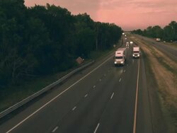 MS TD Shot of truck and auto traffic on interstate highway at dusk / Chelsea, Michigan, United States Stock Footage