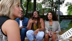 MS PAN Smiling group of friends hanging out in backyard on summer evening Stock Footage