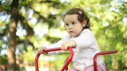 Girl playing on seesaw. Stock Footage