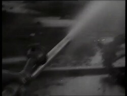 B/W 1960's PAN hose spraying water on destruction / Vietnam / SOUND Stock Footage