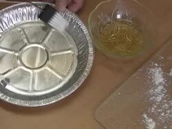 putting olive oil on a pie tin Stock Footage