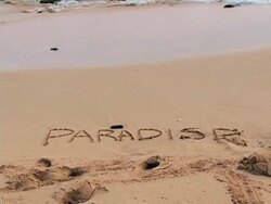 Word paradise written in the sand Stock Footage