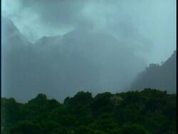 WA fog swirling around amongst jungle covered mountains, Uganda, Africa Stock Footage