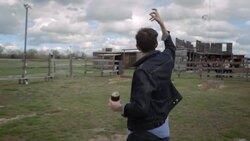 Young man tosses horseshoe at horseshoe pit Stock Footage