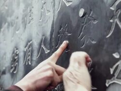  CU Pilgrims touch Chinese character on wall pray for good luck and wealth during Chinese Lunar New Year at Taoist temple / xi'an, shaanxi, china Stock Footage