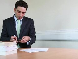 Suited male lawyer checking smart phone Stock Footage
