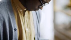 Young man checks shirt price tags in clothing store Stock Footage