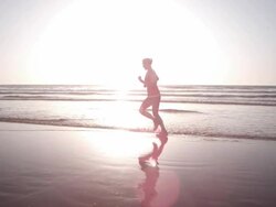 Jogging at the beach Stock Footage
