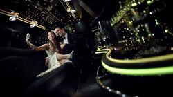 Glamorous couple pose and snap photos with smartphone in limousine at awards show Stock Footage