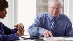MS PAN Mature businessman leading coworkers in project discussion at office conference room table Stock Footage