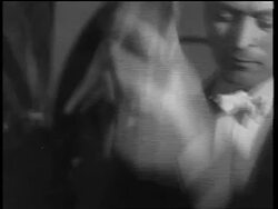 B/W 1933 close up tilt down man in formalwear shaking drink in cocktail shaker / end of Prohibition Stock Footage