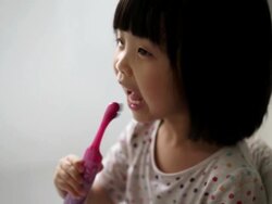 Asian female child enjoying her tooth brushing routine Stock Footage