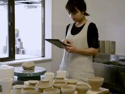 MS Shot of Potter woman is using digital tablet in studio / Kyoto, Japan Stock Footage